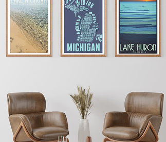 Three prints on wall behind two leather chairs